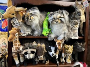 Realistic Hansa plush animal toys on a shelf