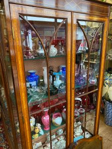 A cabinet of fine coloured glassware