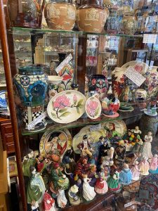 A cabinet of decorative pottery, vases and figurines